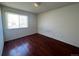 Simple bedroom with hardwood floors and window at 12076 E Montana Pl, Aurora, CO 80012