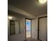 Basement hallway with mirrored wall and access to other rooms at 12076 E Montana Pl, Aurora, CO 80012