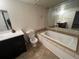 Bathroom with soaking tub, toilet and dark vanity at 12076 E Montana Pl, Aurora, CO 80012