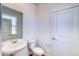 Simple and clean powder room with pedestal sink and toilet at 8669 Middle Fork St, Littleton, CO 80125