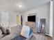 Cozy bedroom with wood-look floors, a dresser, and a flat-screen TV at 2281 S Vaughn Way # 111A, Aurora, CO 80014