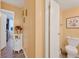 Clean hallway with a small table and view into bedroom at 2281 S Vaughn Way # 111A, Aurora, CO 80014
