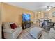 Bright living room with hardwood floors, comfortable seating and a view into the dining area at 2281 S Vaughn Way # 111A, Aurora, CO 80014