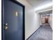 Clean hallway with neutral walls and doors leading to individual units at 2281 S Vaughn Way # 111A, Aurora, CO 80014
