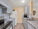 Modern kitchen with gray cabinets, granite countertops, and stainless steel appliances at 2281 S Vaughn Way # 111A, Aurora, CO 80014