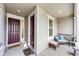 Inviting front porch with seating area and decorative pillows at 17062 Desert Wine Ln, Parker, CO 80134