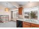 Kitchen with double sinks, dishwasher, and a view to the backyard from the window at 19867 E Brown Pl, Aurora, CO 80013