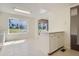 Kitchen features white cabinets, tile floor, and backyard view at 2466 S Vaughn Way # B, Aurora, CO 80014