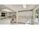 Efficient kitchen with white cabinets and speckled countertops at 2466 S Vaughn Way # B, Aurora, CO 80014