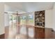 Open living room with hardwood floors, fireplace, and access to patio at 2466 S Vaughn Way # B, Aurora, CO 80014