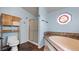 Bathroom with shower, bathtub, and stained glass window at 201 E Maple St, Elizabeth, CO 80107