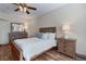 Bedroom with wooden bedframe, matching nightstands and dresser, and ceiling fan at 6631 E 167Th Ave, Brighton, CO 80602