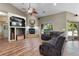 Living room with fireplace, built-in entertainment center, and wood floors at 6631 E 167Th Ave, Brighton, CO 80602