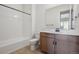 Clean bathroom with a tub, toilet, and modern vanity at 4117 River Oaks St, Castle Rock, CO 80104