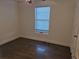 Simple bedroom with wood-look floors and a window with blinds at 3114 W Gill Pl, Denver, CO 80219