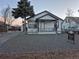 White house with a gravel front yard and black accents at 3114 W Gill Pl, Denver, CO 80219