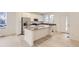Modern kitchen with white cabinets, stainless steel appliances and an island at 14554 W 91St Dr # A, Arvada, CO 80005