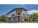 Commercial building with stone facade and outdoor seating at 14554 W 91St Dr # A, Arvada, CO 80005