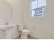 Simple and updated half bathroom with pedestal sink and toilet at 14554 W 91St Dr # A, Arvada, CO 80005