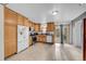Kitchen with wood cabinets, stainless steel appliances, and tiled floor at 1550 S Telluride St, Aurora, CO 80017