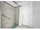 Bathroom with shower stall, grab bar, and tiled walls at 1550 S Telluride St, Aurora, CO 80017
