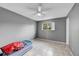 Simple bedroom with gray walls, tile floor, and ceiling fan at 1550 S Telluride St, Aurora, CO 80017
