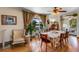 Bright dining room features hardwood floors, a large table, and views of the backyard at 1637 S Us Highway 287, Berthoud, CO 80513