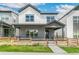 Two-story home with gray and white exterior and wooden fence at 3450 W 62Nd Pl, Denver, CO 80221