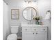 Clean bathroom, featuring a vanity with a round mirror at 115 Willowick Cir, Highlands Ranch, CO 80129