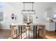 Light-filled dining area with a wooden table and modern light fixture at 115 Willowick Cir, Highlands Ranch, CO 80129