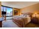 Spacious bedroom with city view and wood furniture at 1625 Larimer St # 904, Denver, CO 80202