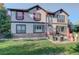 Large backyard with patio, seating area, and mature trees at 5033 Silver Feather Way, Broomfield, CO 80023