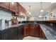 Basement bar with granite countertop and wood cabinetry at 5033 Silver Feather Way, Broomfield, CO 80023