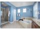 Bathroom with soaking tub, shower, and double sinks at 5033 Silver Feather Way, Broomfield, CO 80023