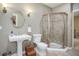 Bathroom featuring a pedestal sink, toilet and shower at 5033 Silver Feather Way, Broomfield, CO 80023