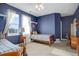 Spacious bedroom with two twin beds, a desk, and large windows at 5033 Silver Feather Way, Broomfield, CO 80023
