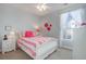 Cozy bedroom with pink accents and a ceiling fan at 5033 Silver Feather Way, Broomfield, CO 80023
