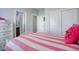 Bright bedroom with striped bedding and built-in shelving at 5033 Silver Feather Way, Broomfield, CO 80023