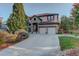 Two-story house with stone accents, red shutters, and a three-car garage at 5033 Silver Feather Way, Broomfield, CO 80023