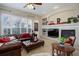 Spacious living room features a fireplace and comfortable leather seating at 5033 Silver Feather Way, Broomfield, CO 80023