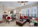 Spacious living room featuring a leather sectional sofa, plush armchairs, and hardwood floors at 5033 Silver Feather Way, Broomfield, CO 80023