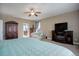 Relaxing main bedroom with a large bed, fireplace, and walk-in closet at 5033 Silver Feather Way, Broomfield, CO 80023