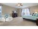 Bright main bedroom with a king-size bed and a seating area at 5033 Silver Feather Way, Broomfield, CO 80023
