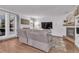 Living area with hardwood floors, gray sofas, and a brick fireplace at 6131 Xavier Ct, Arvada, CO 80003