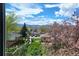 View from window showing neighborhood, mountains, and spring blossoms at 9560 W 38Th Ave, Wheat Ridge, CO 80033