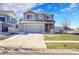 Two-story house with gray siding, attached garage, and landscaped front yard at 5399 Walden Ct, Denver, CO 80249