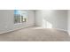 Bright bedroom with neutral carpeting and window coverings at 2971 Pershing St, Strasburg, CO 80136
