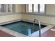 Community hot tub with metal handrails and surrounding tile work at 3230 Boulder Cir # 101, Broomfield, CO 80023