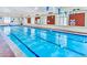 Indoor community pool with lane lines and safety signage at 3230 Boulder Cir # 101, Broomfield, CO 80023