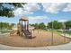 Community playground with swings, slides, and benches at 3230 Boulder Cir # 101, Broomfield, CO 80023